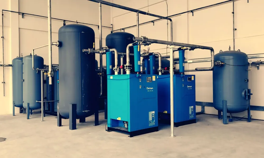 Industrial air compressor system with blue tanks and piping