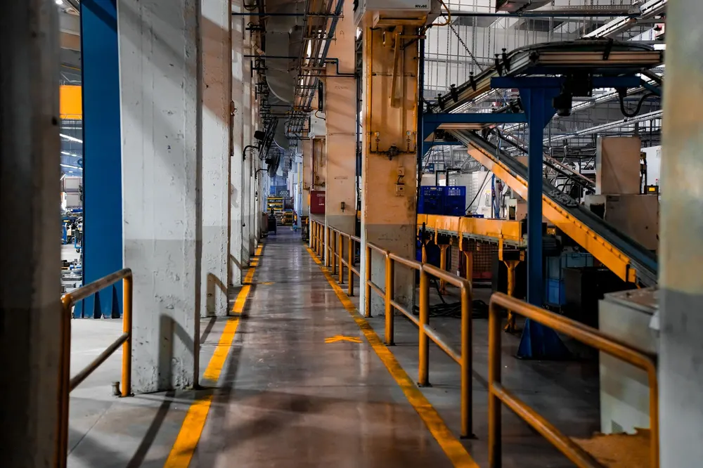 Industrial factory interior with conveyor belt lines and walkways